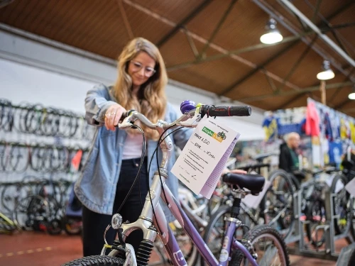 A woman looking at a bike in a store