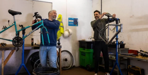 Two people working on bikes at the same time