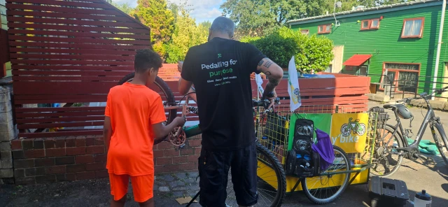 A man helping a child with a bike